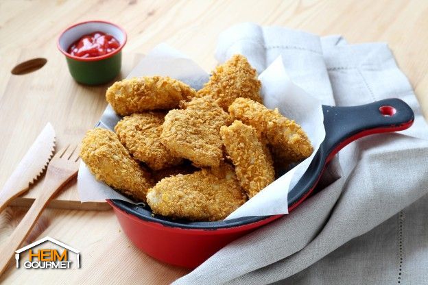 Die panierten Filetstücke auf ein Backblech legen